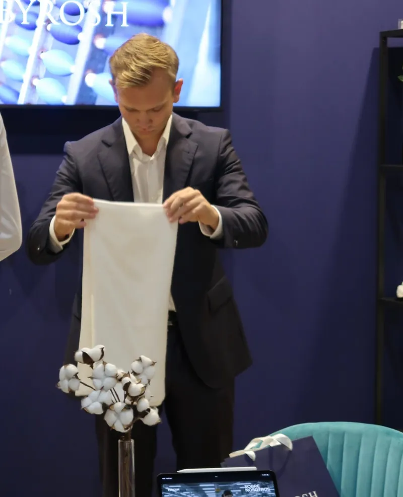 BYROSH co-founder presenting a towel at InteriHOTEL